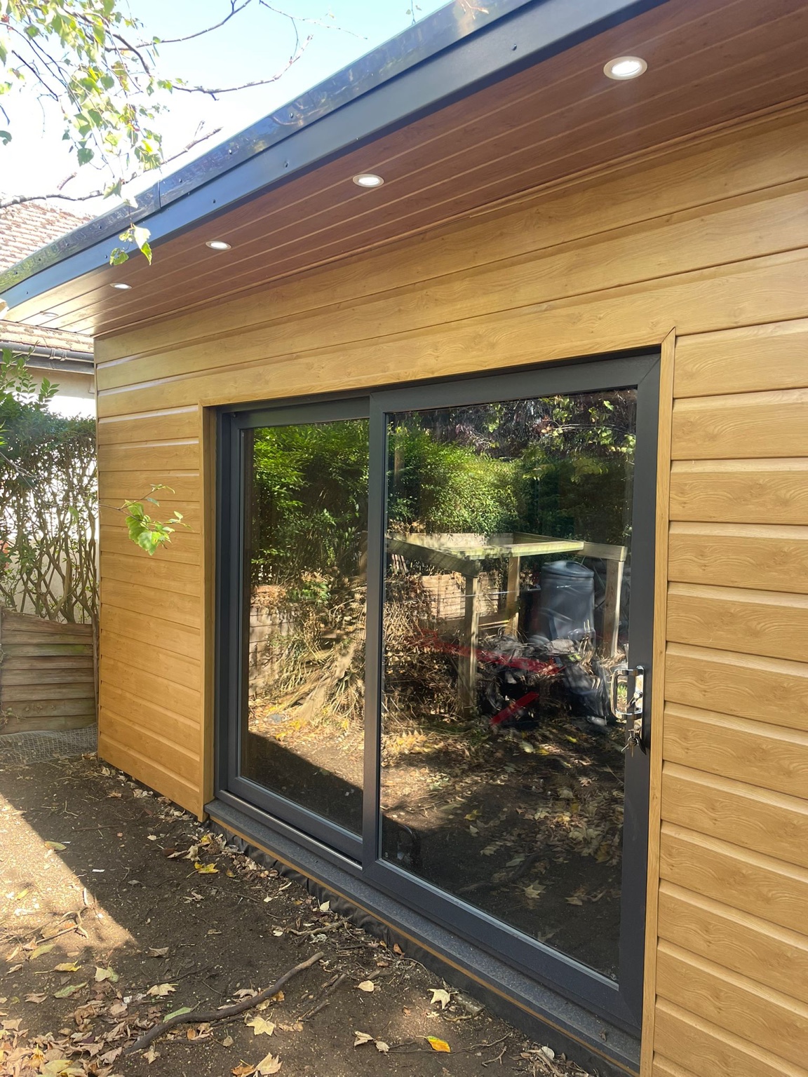 Cedar-effect cladding with LED canopy lights in Cheshire